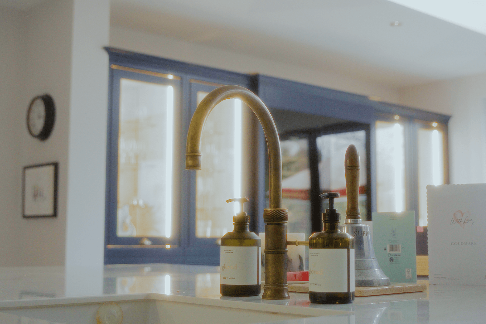 Beckenham home interiors kitchen brass tap with soap dispensers and styled island details