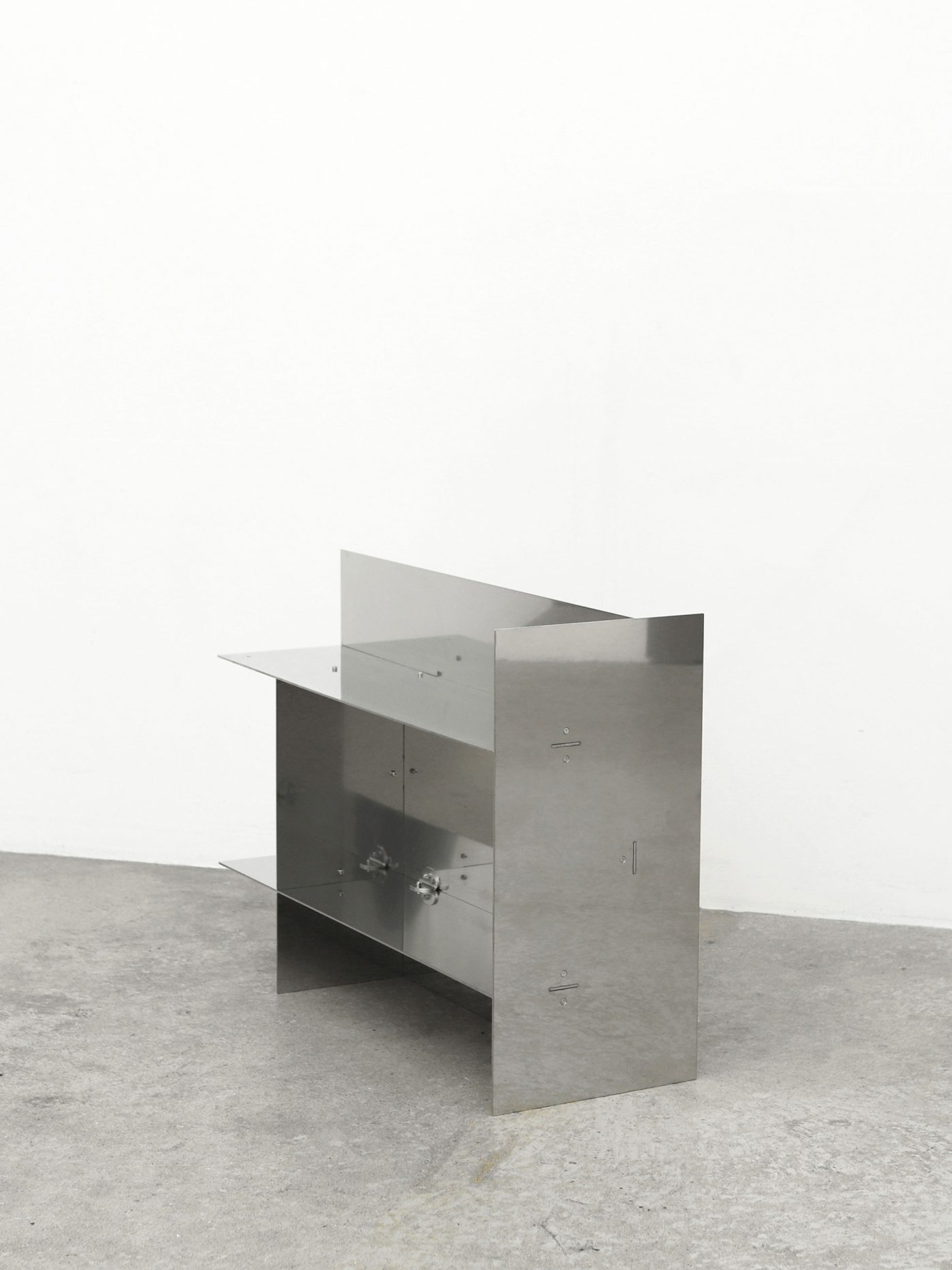 Placeholder reference image: Metal side table formed from intersecting vertical planes and a thin top.