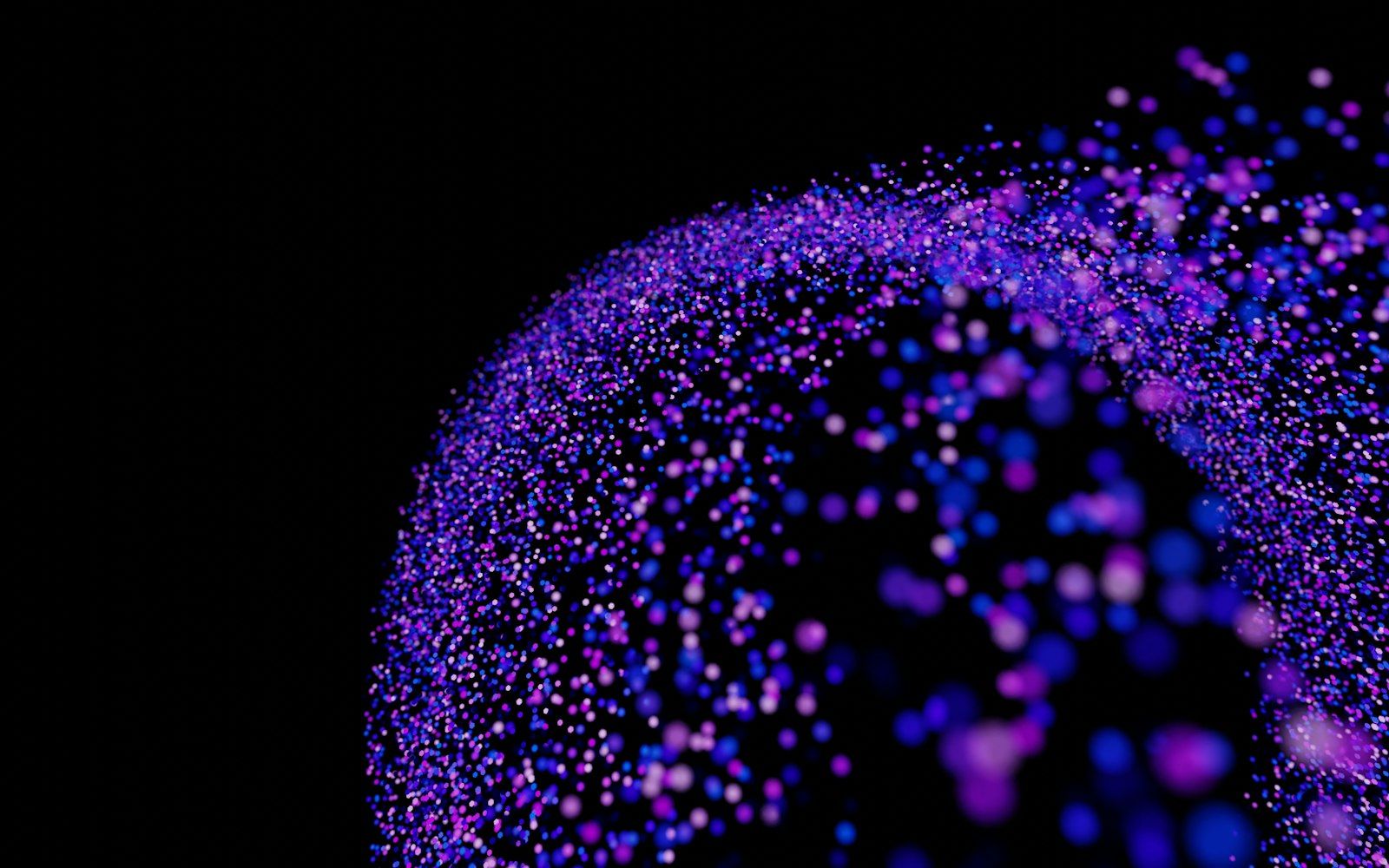 A sphere of glowing purple and blue particles on black