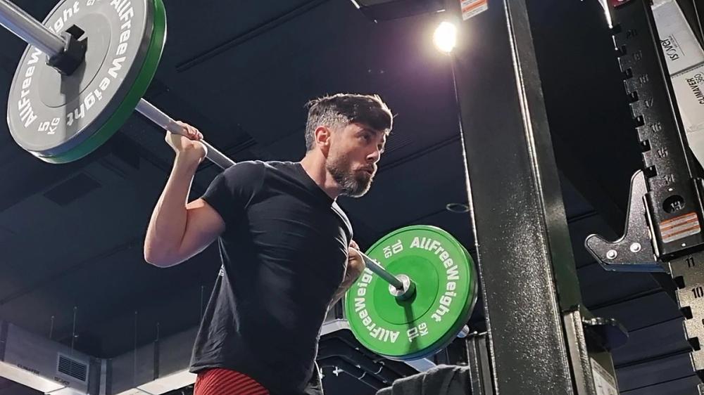 How should you manage your breathing during strength training?