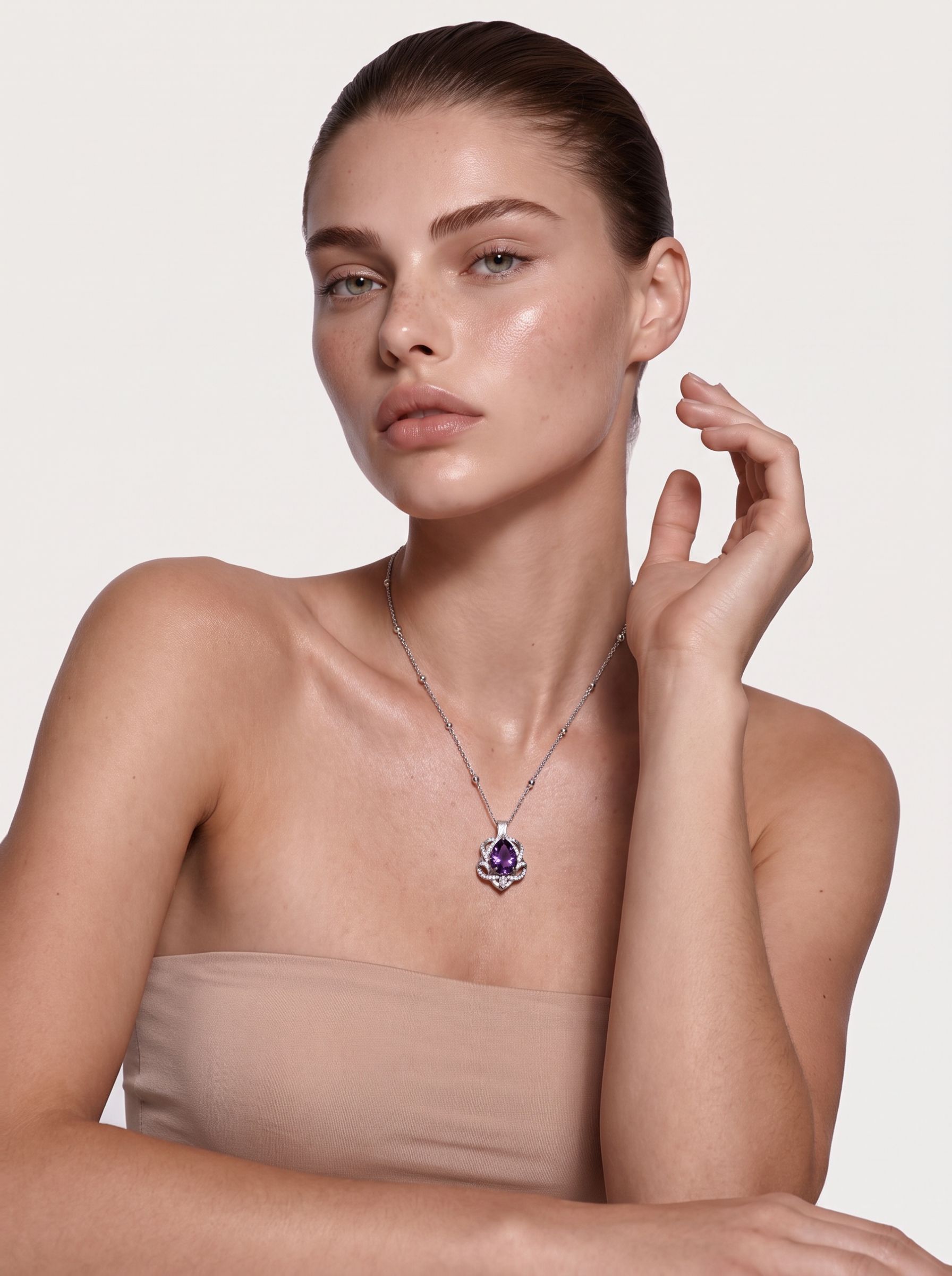 Amethyst pear pendant in sterling silver worn at the neckline