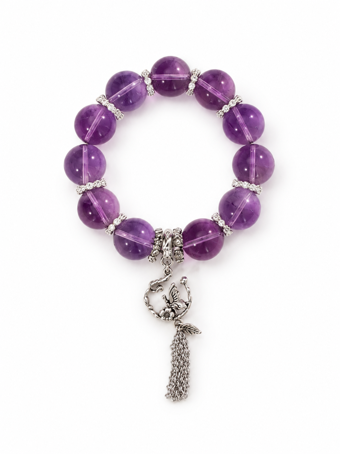 Eye-clean amethyst beaded bracelet with 16 mm violet beads, antique-finish sterling silver spacers and a silver charm with tassel on a white background
