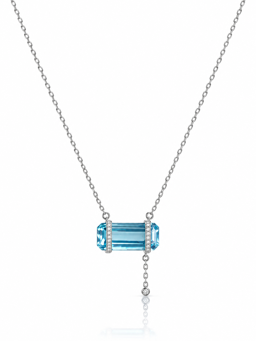 Emerald-cut aquamarine bar pendant necklace set horizontally with cubic zirconia end caps in sterling silver on a white background
