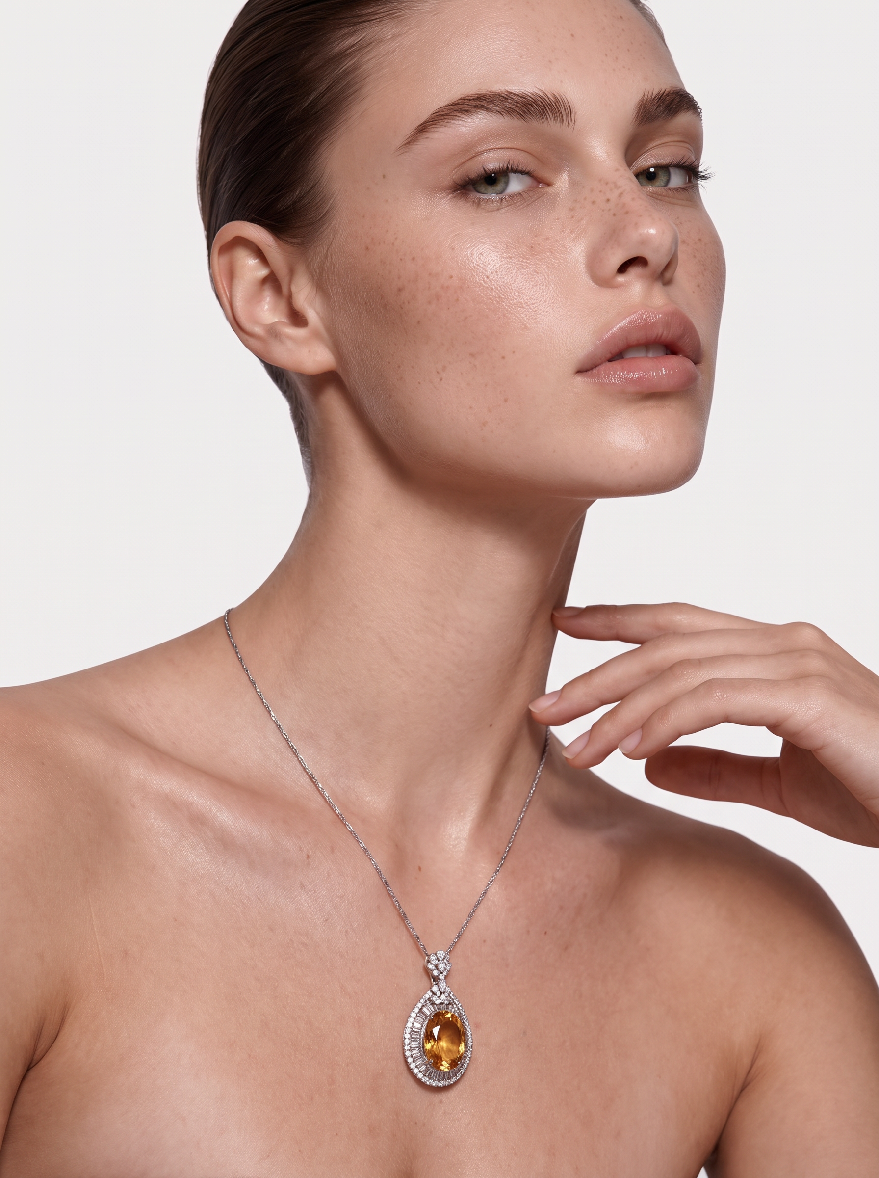 Model wearing the Honey Pool citrine halo pendant necklace, hand raised to the chin