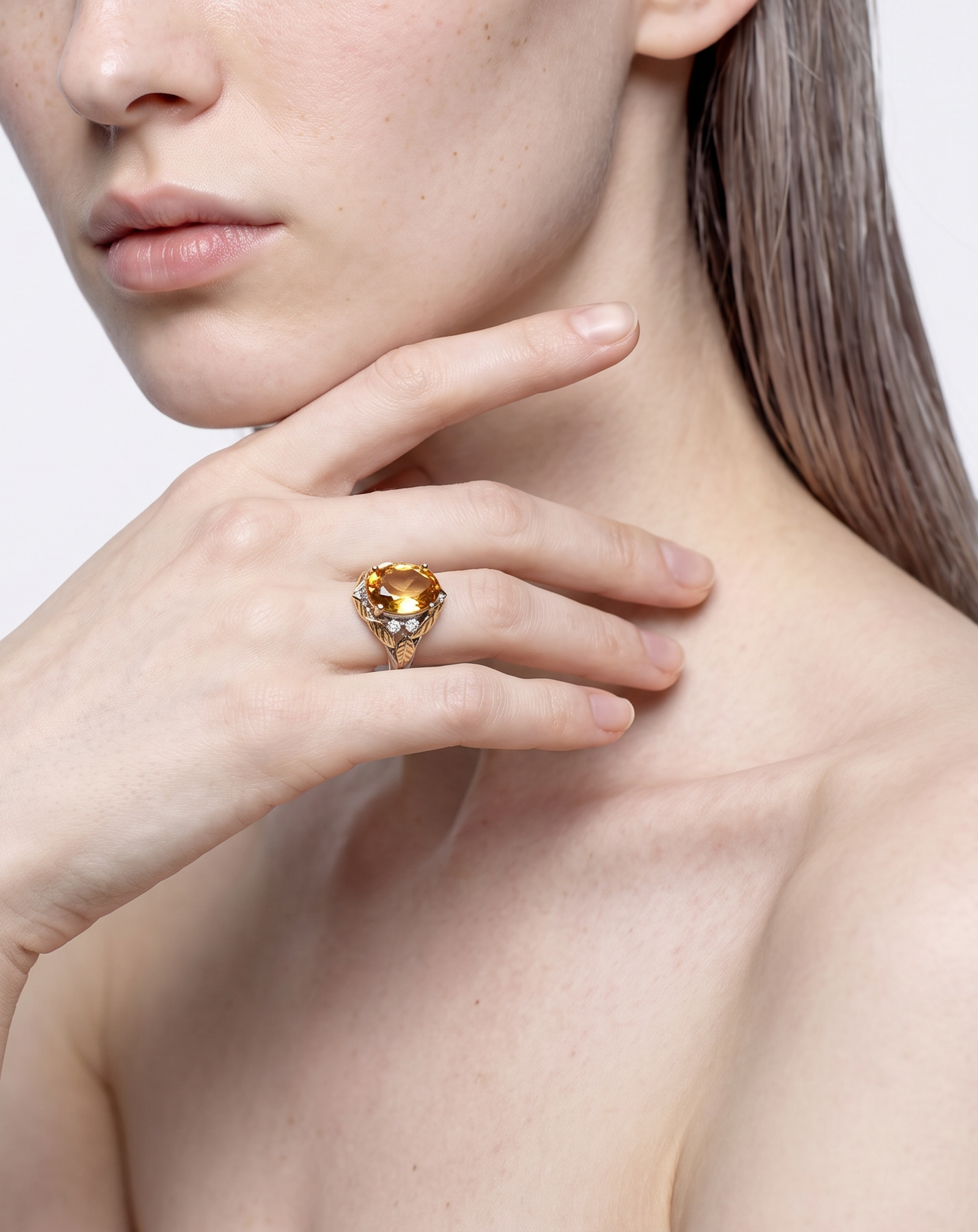 Model wearing the Sun Leaf citrine leaf ring, hand raised to the chin
