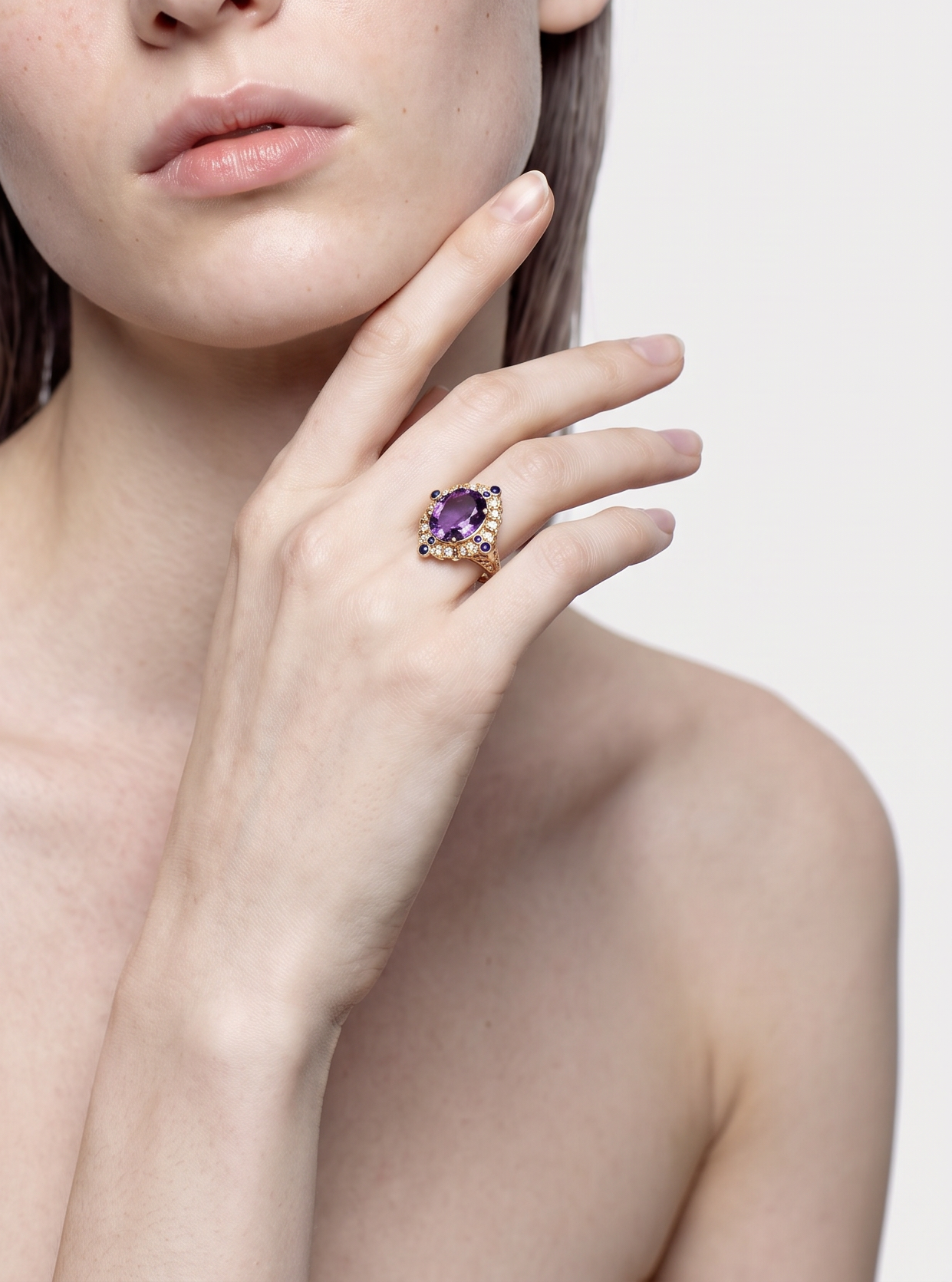 Model wearing the Lapis Crown amethyst and lapis lazuli ring, hand at the chin