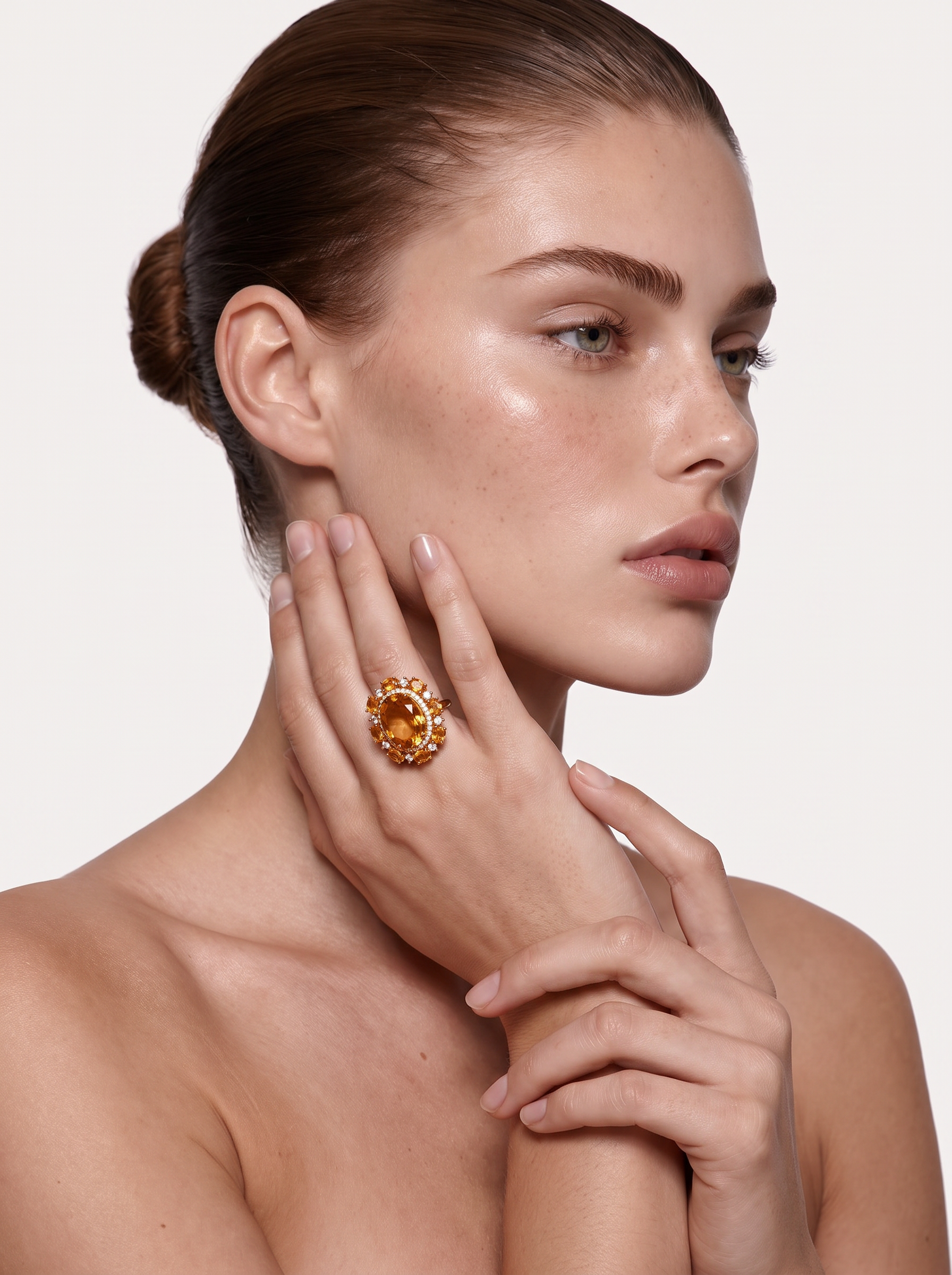 Citrine cocktail ring worn on the finger, hand raised to the face