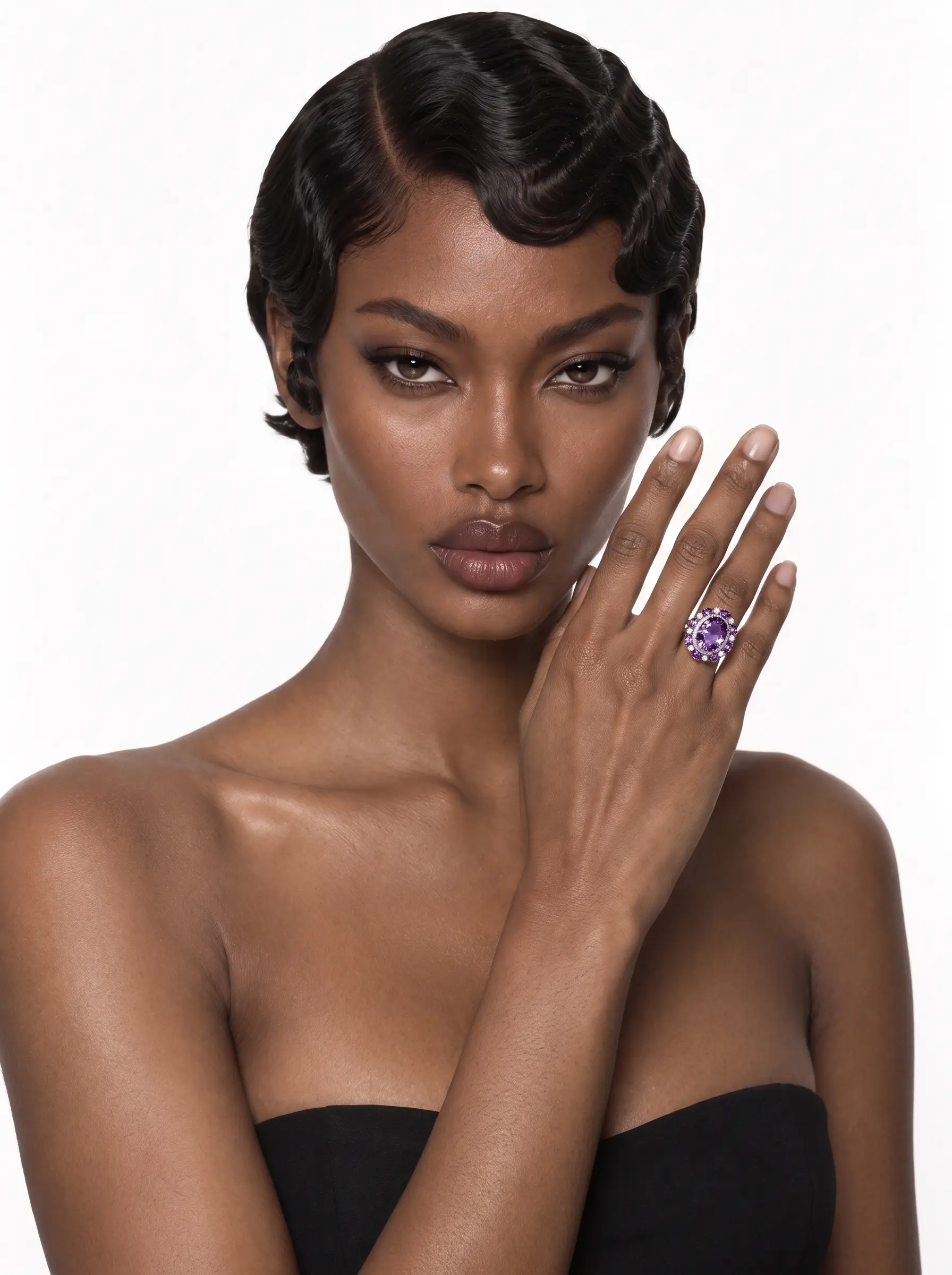 Amethyst cluster ring worn on the finger, hand raised to the face