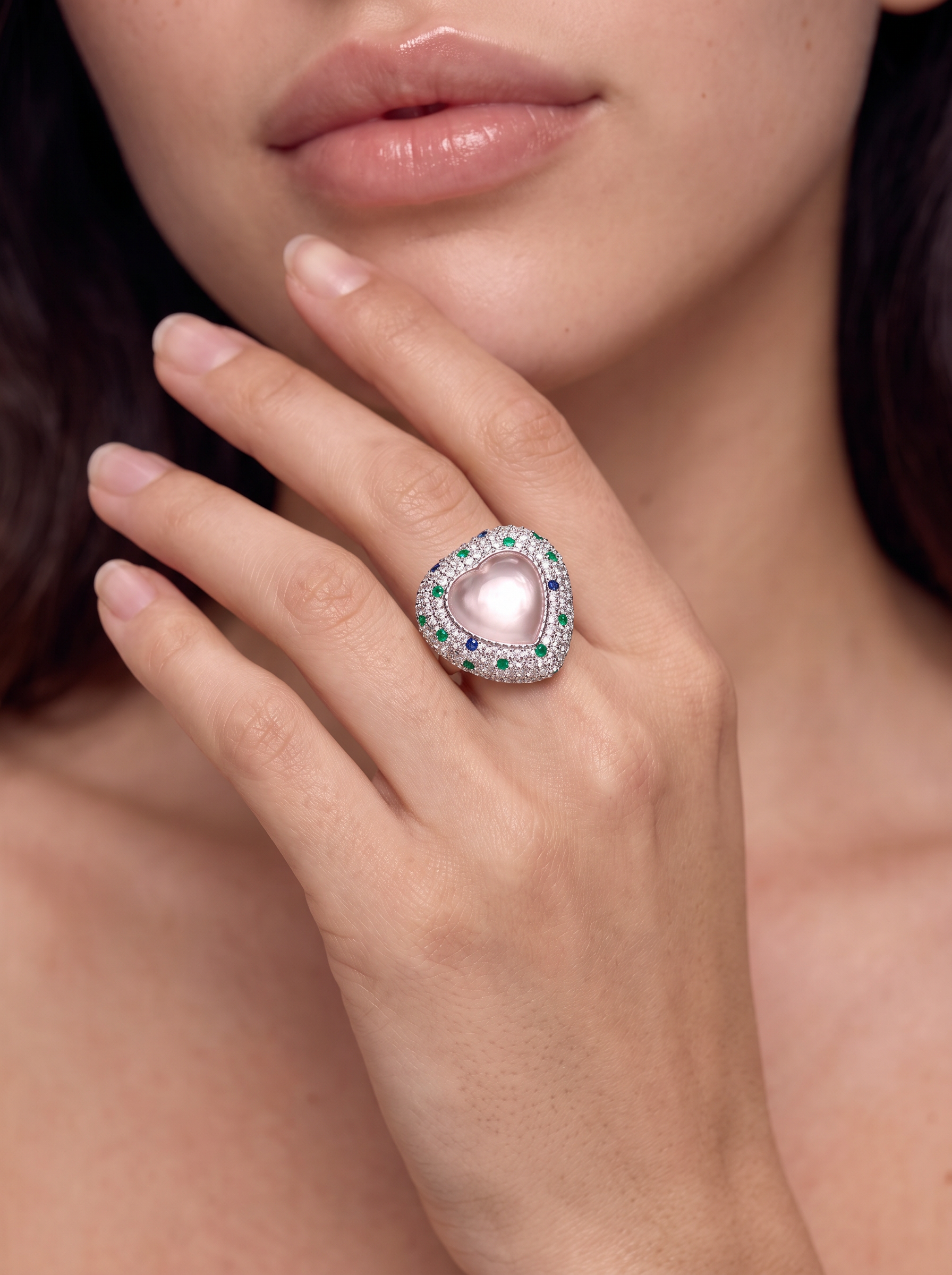 Close-up of the Siren's Heart rose quartz ring worn on the finger