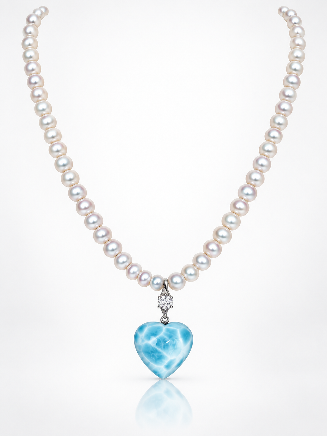 Freshwater pearl necklace with a blue and white larimar heart pendant on a white background