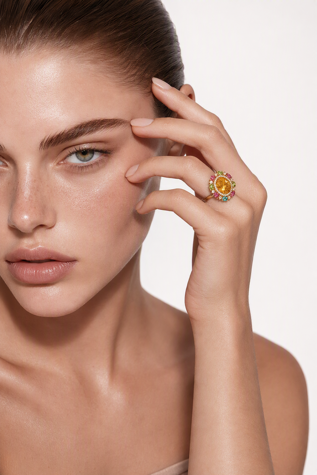 Model wearing the citrine and multicolour tourmaline ring, hand raised to the brow