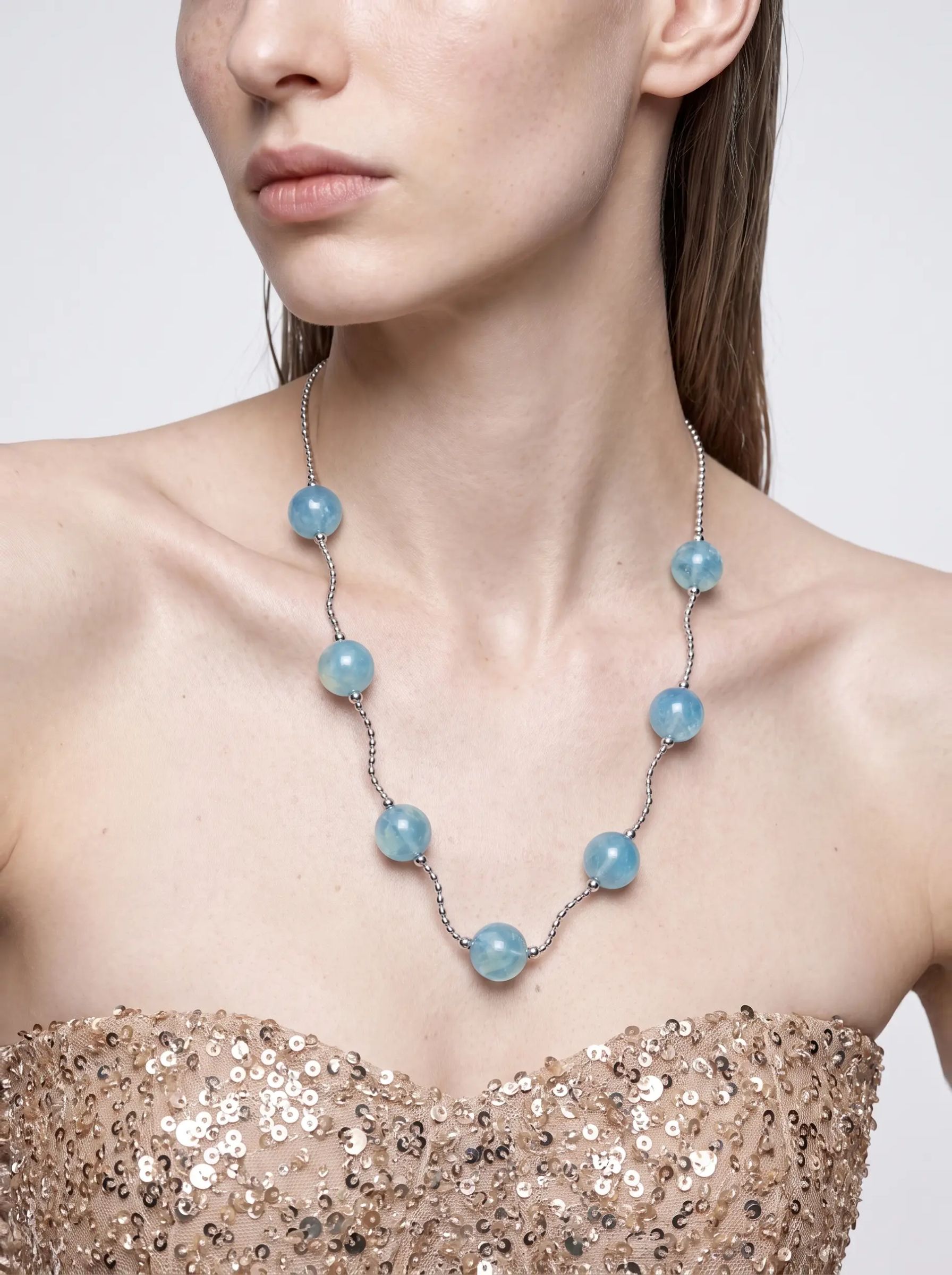 Model wearing the Tidewater aquamarine station necklace, close view at the neckline