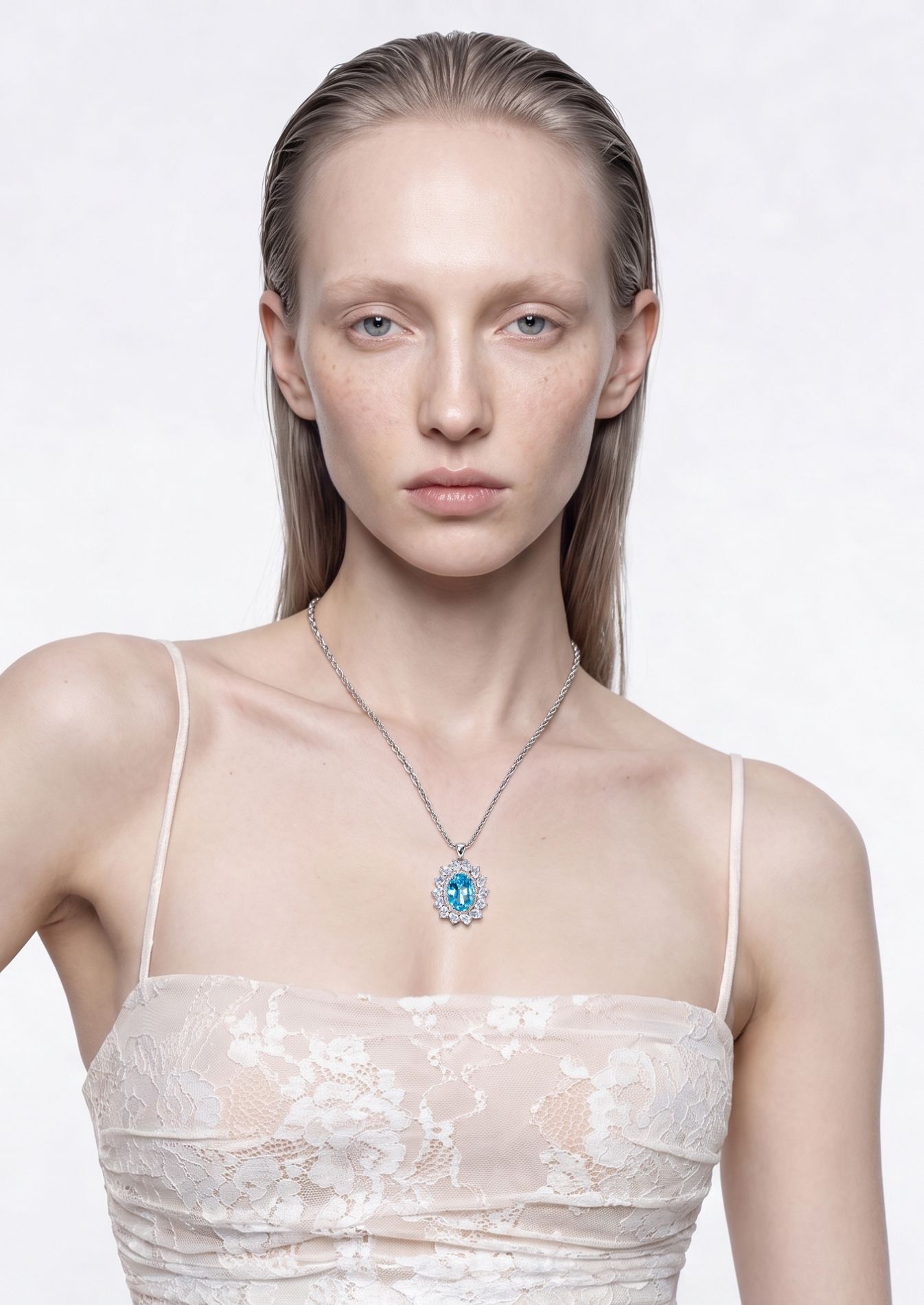 Model wearing the Sea Bloom blue topaz and aquamarine pendant necklace