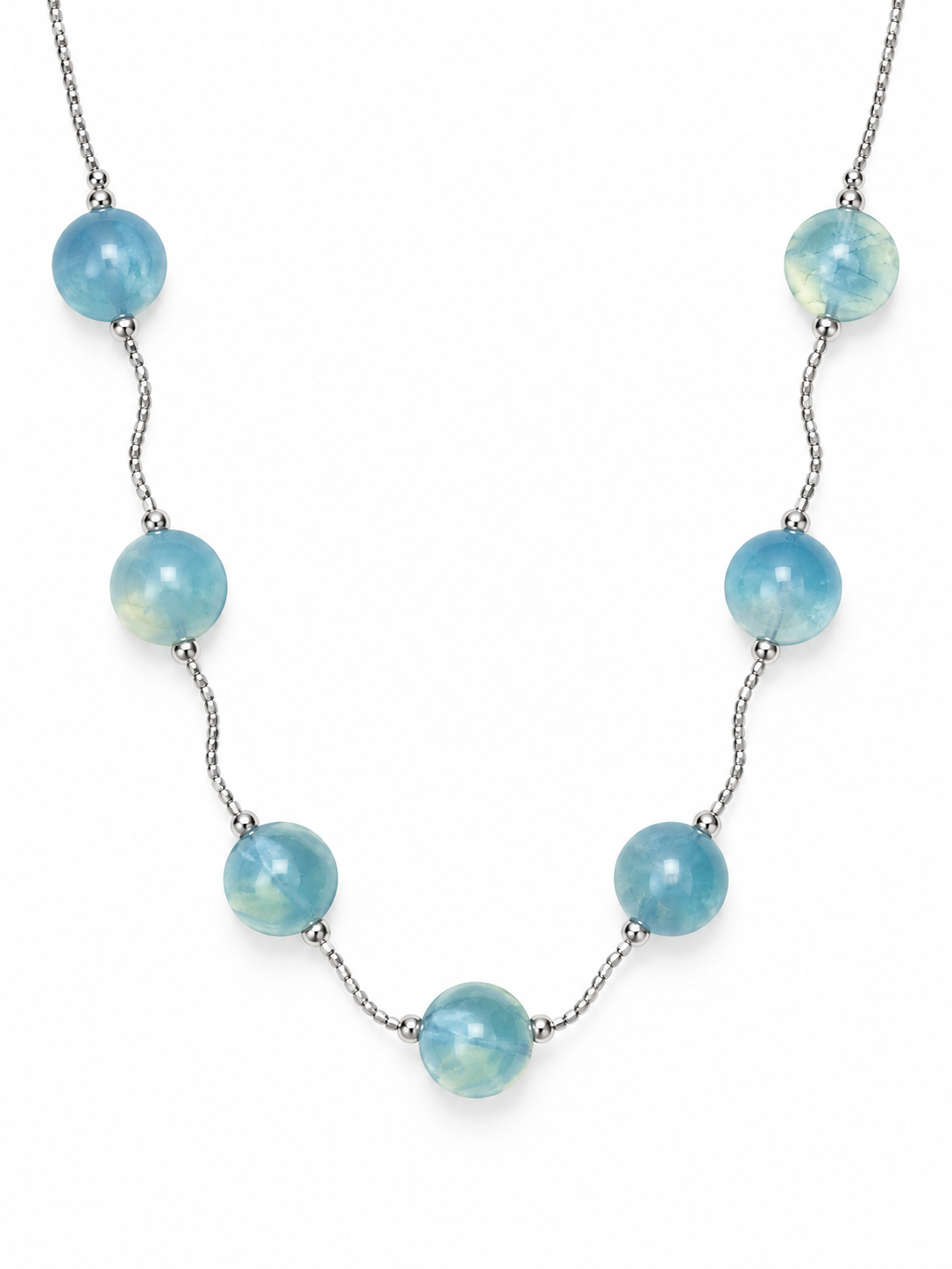 Aquamarine station necklace with seven 16 mm sea-blue spheres on a twisted sterling silver chain on a white background