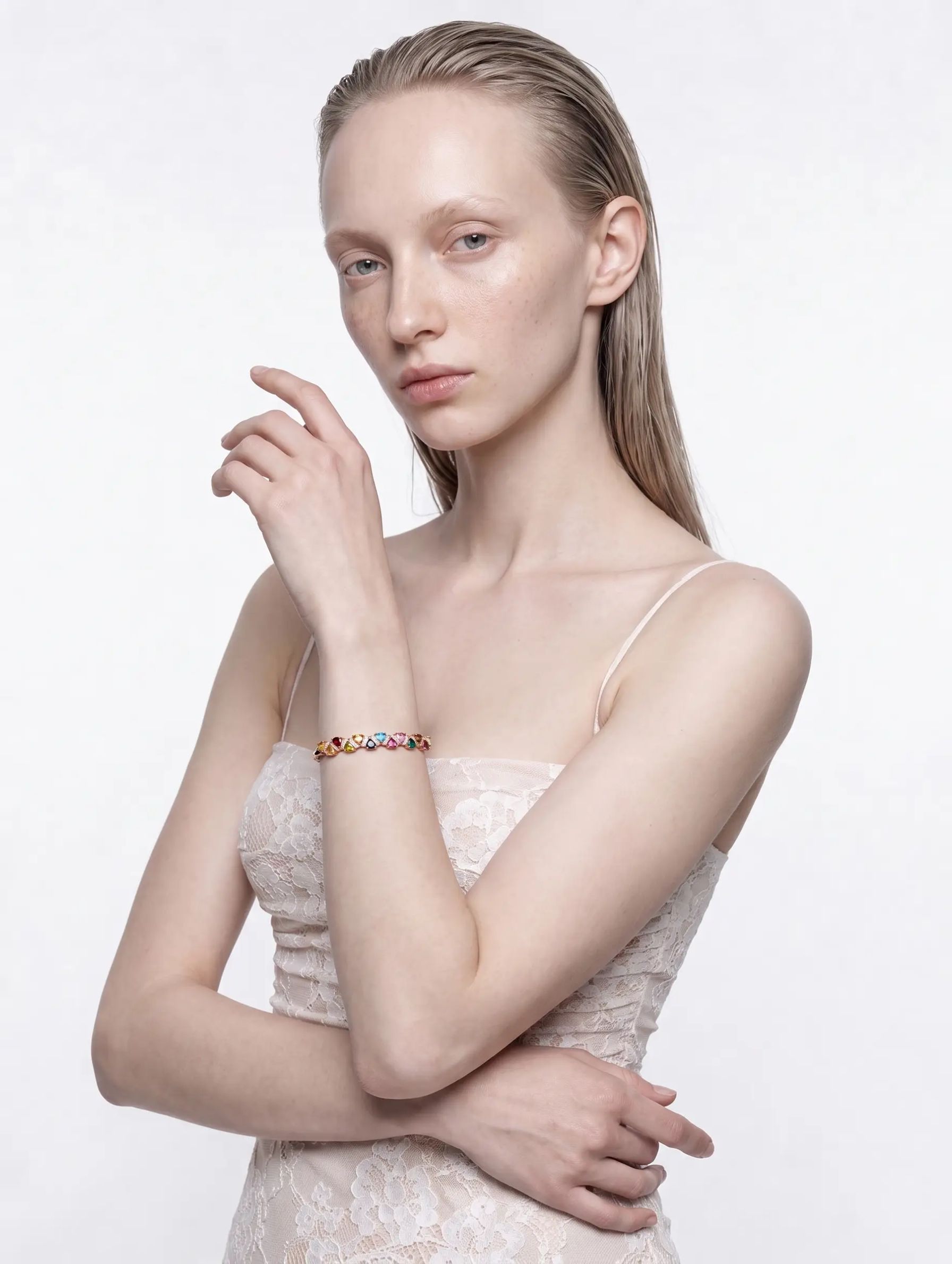 Model wearing the Coral Garden multicolour tourmaline bangle in rose gold, full-length view