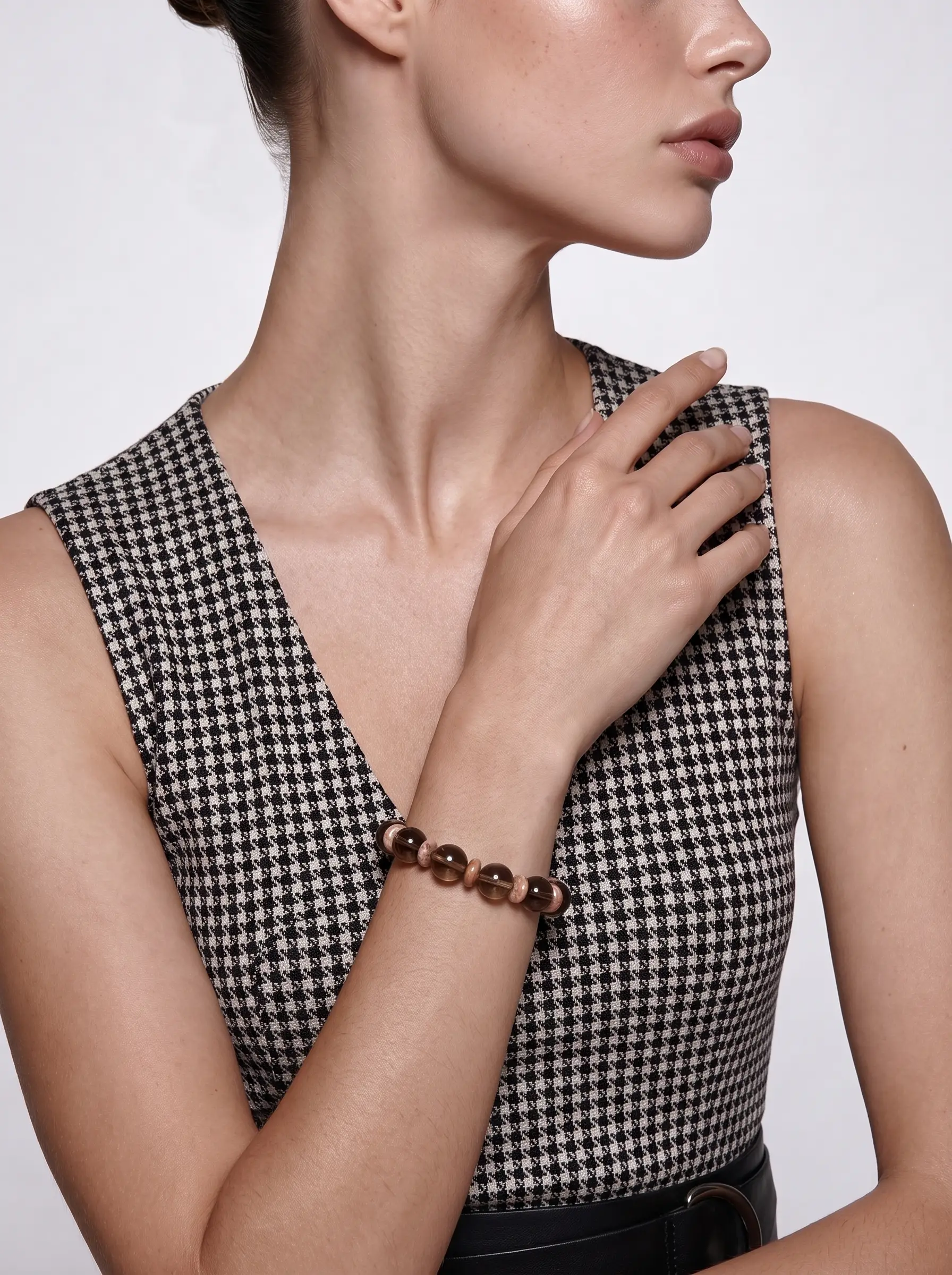 Model wearing the Driftwood Hour smoky quartz and Alxa agate beaded bracelet, hand resting at the shoulder