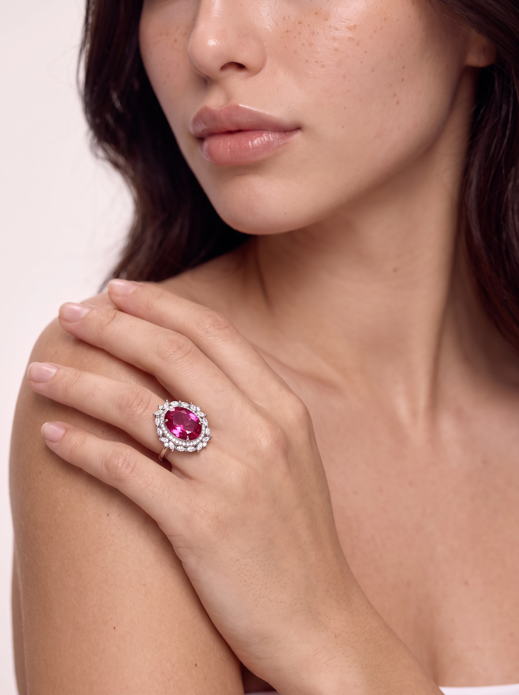 Model wearing the Sea Rose pink topaz ring, hand resting on the shoulder