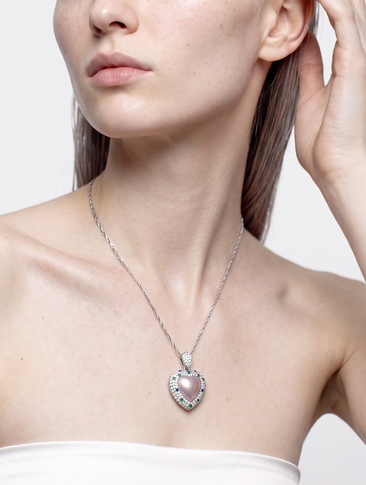 Pink rose quartz heart pendant in sterling silver worn at the neckline