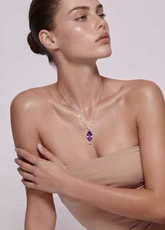 Marquise amethyst pendant in sterling silver worn with a nude bodysuit, seated pose