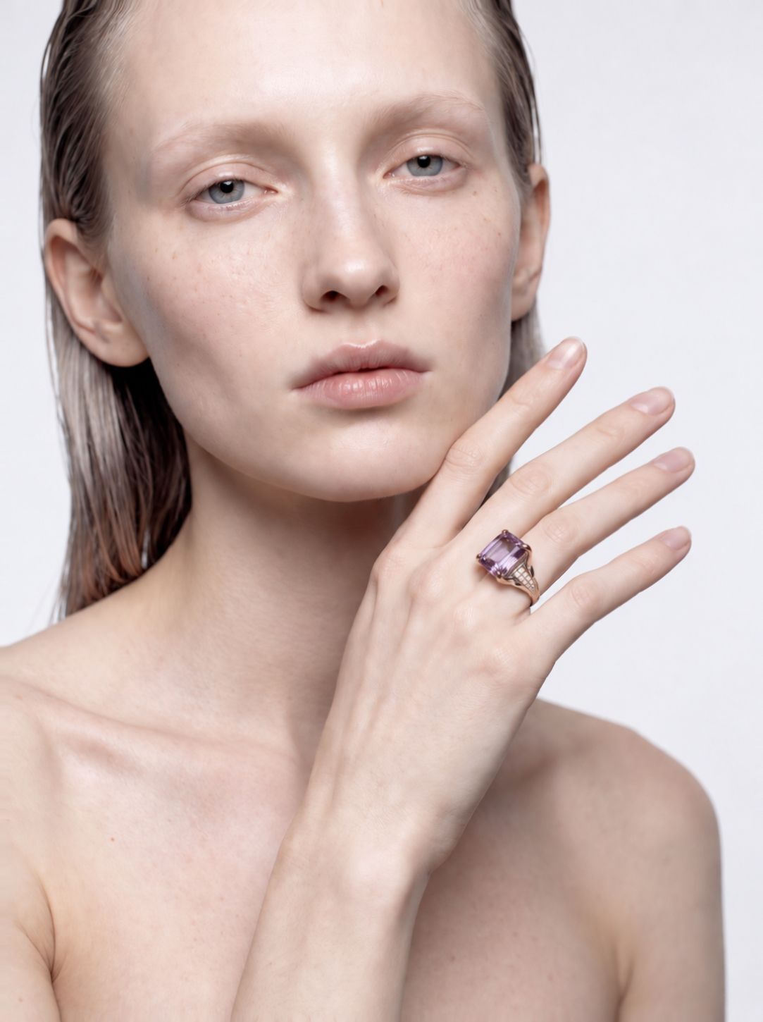 Model wearing the Violet Horizon emerald-cut amethyst ring, hand raised