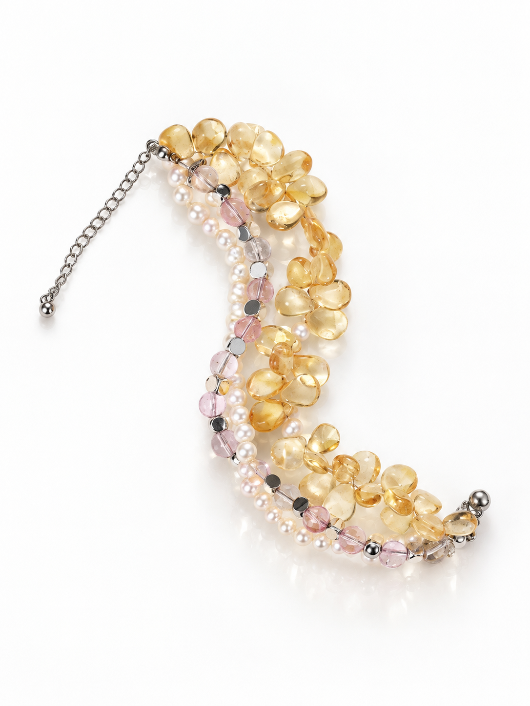 Three-strand bracelet of citrine briolettes, faceted amethyst and freshwater pearls with a sterling silver extension chain on a white background