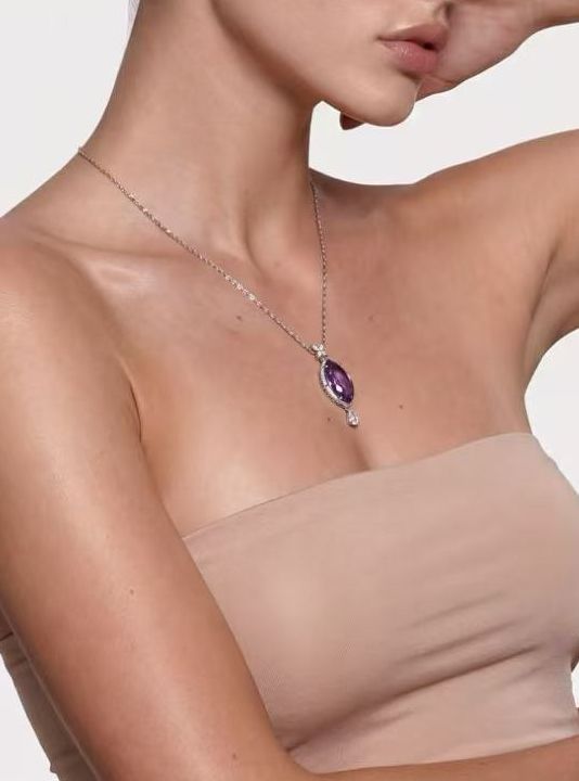Model wearing the Moonlit Current marquise amethyst pendant necklace, arm raised