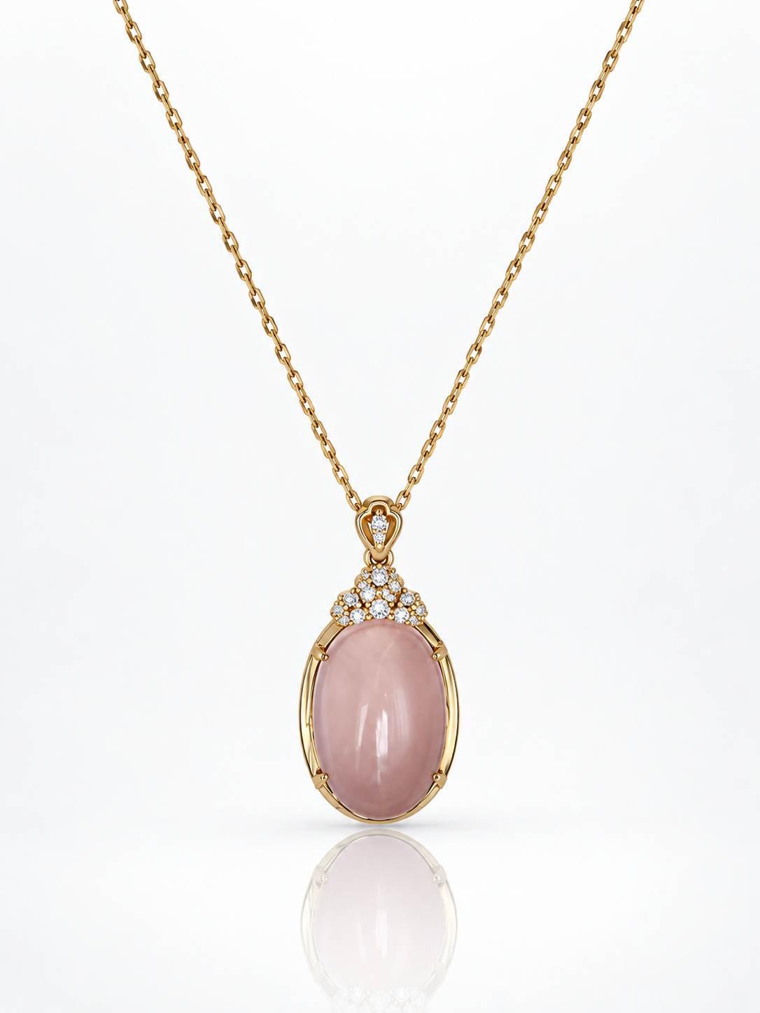 Star rose quartz oval cabochon pendant necklace in 18K gold-plated sterling silver with cubic zirconia crown on a white background