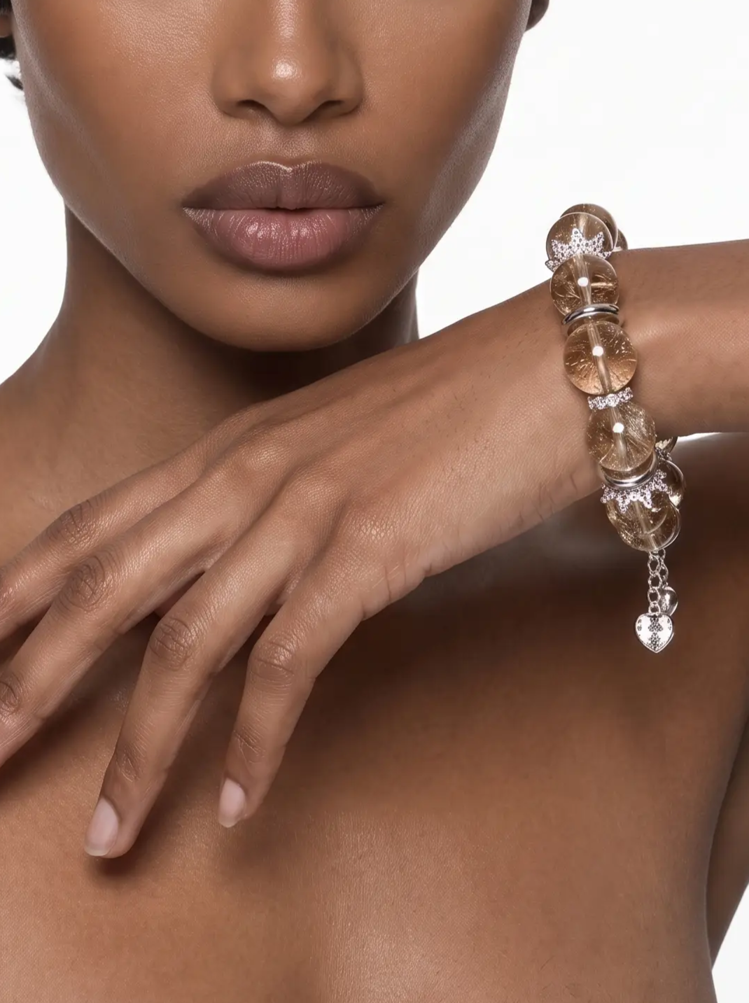 Close-up of the golden rutilated quartz bracelet with sterling silver accents worn on the wrist