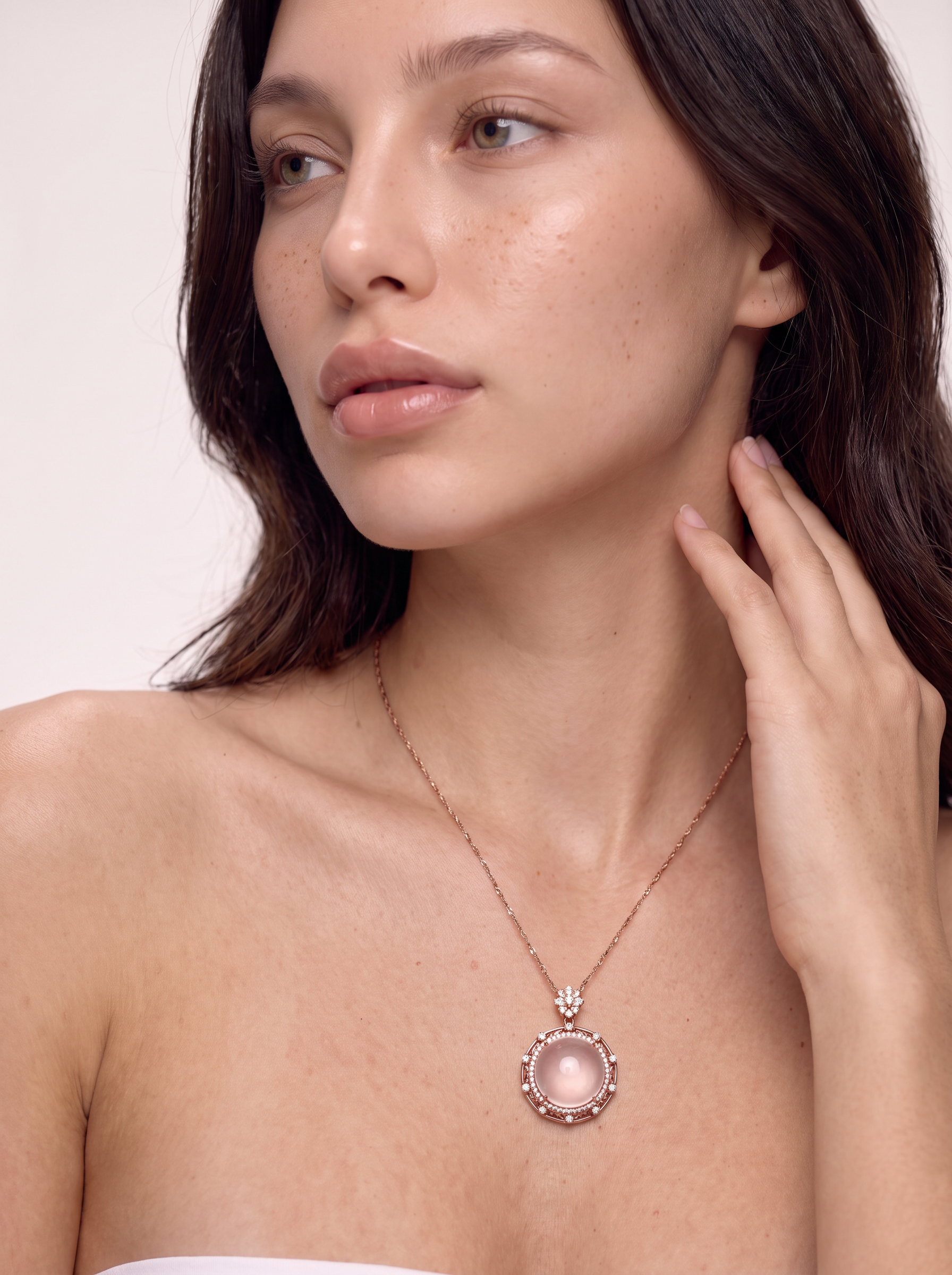 Model wearing the Rose Moon star rose quartz pendant necklace in rose gold, close view