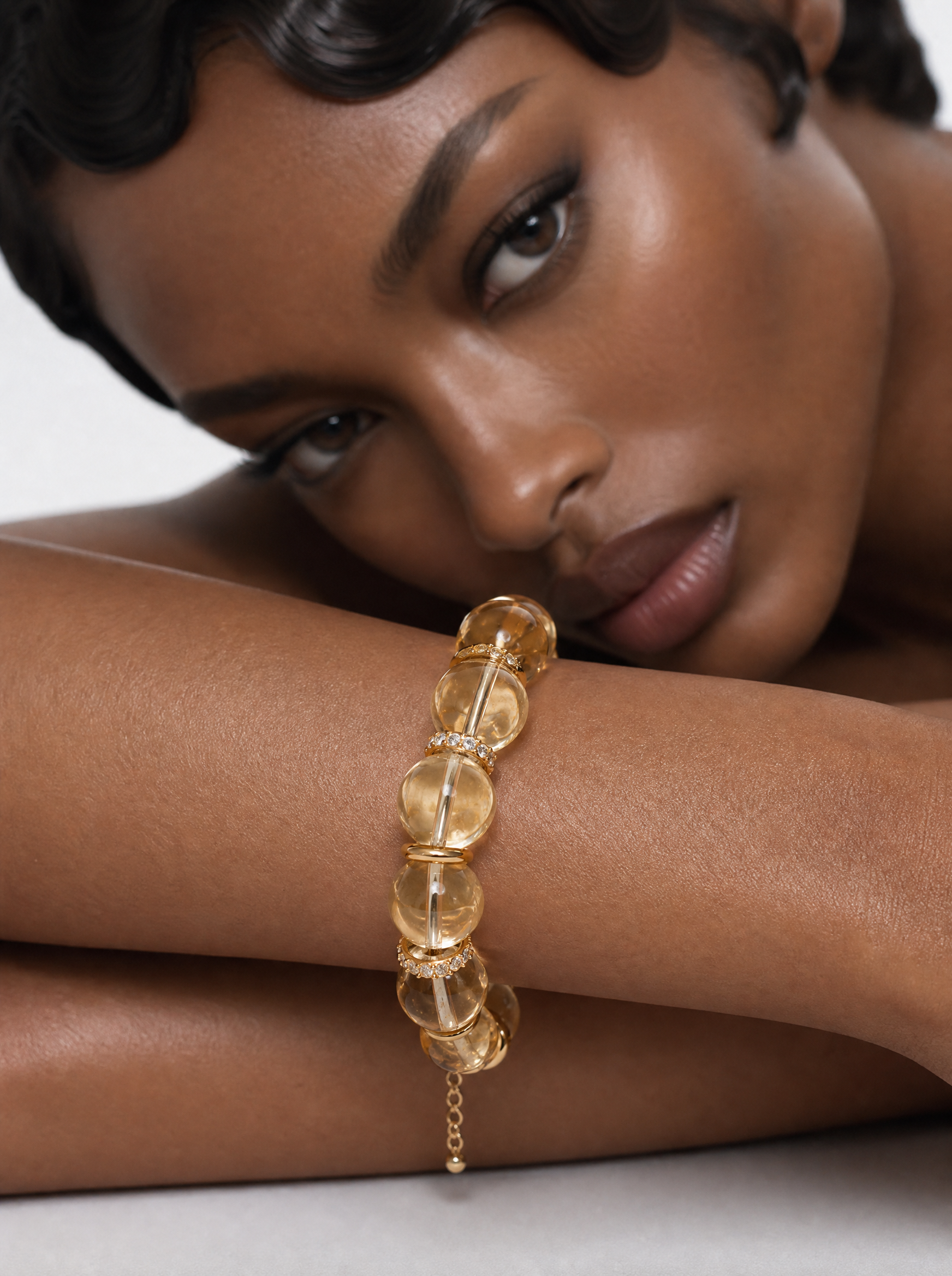 Model wearing the Sunken Gold citrine beaded bracelet, close-up of honey-yellow beads on the forearm