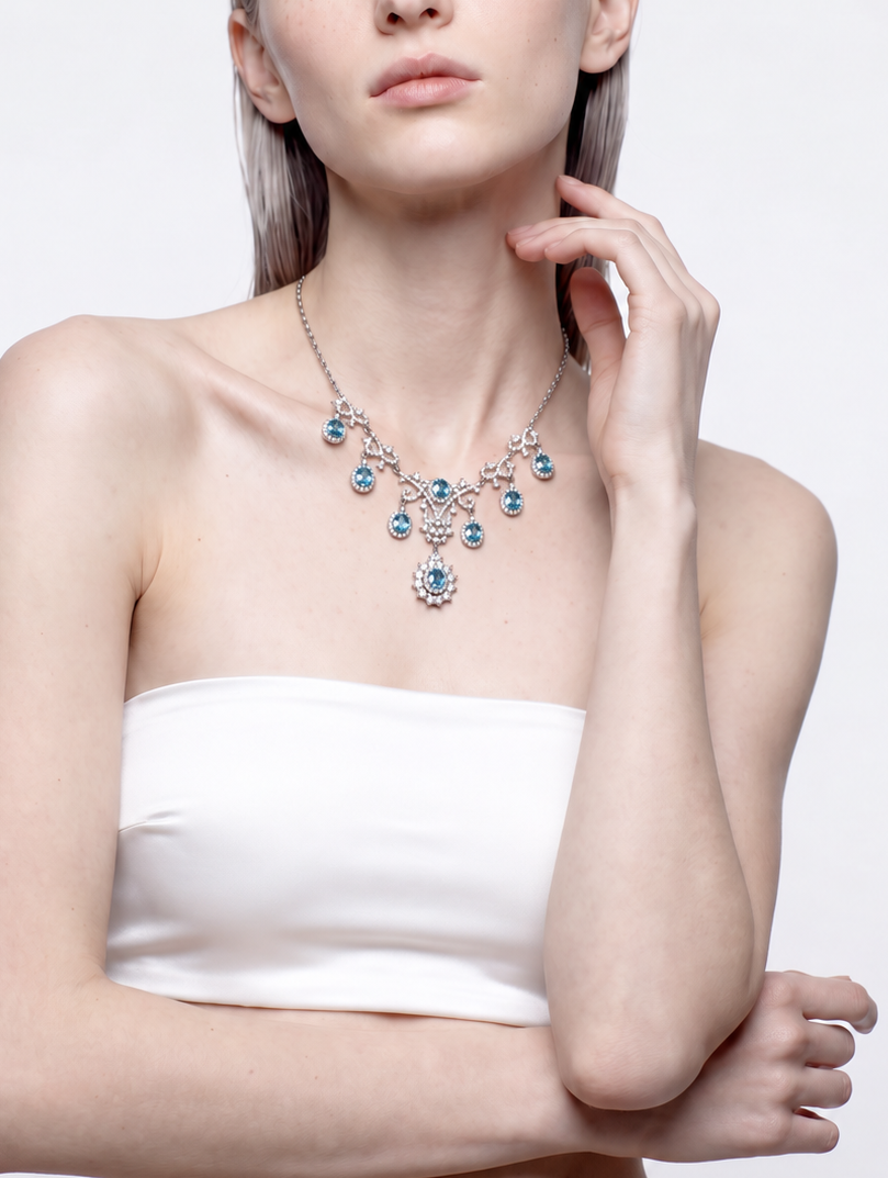 Blue topaz and cubic zirconia statement necklace worn across the collarbone