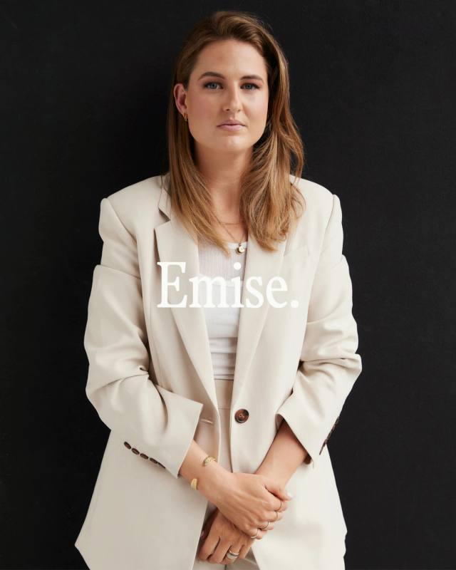 Emma Wiseman in a cream blazer against black, the Emise. wordmark set across the frame in white.