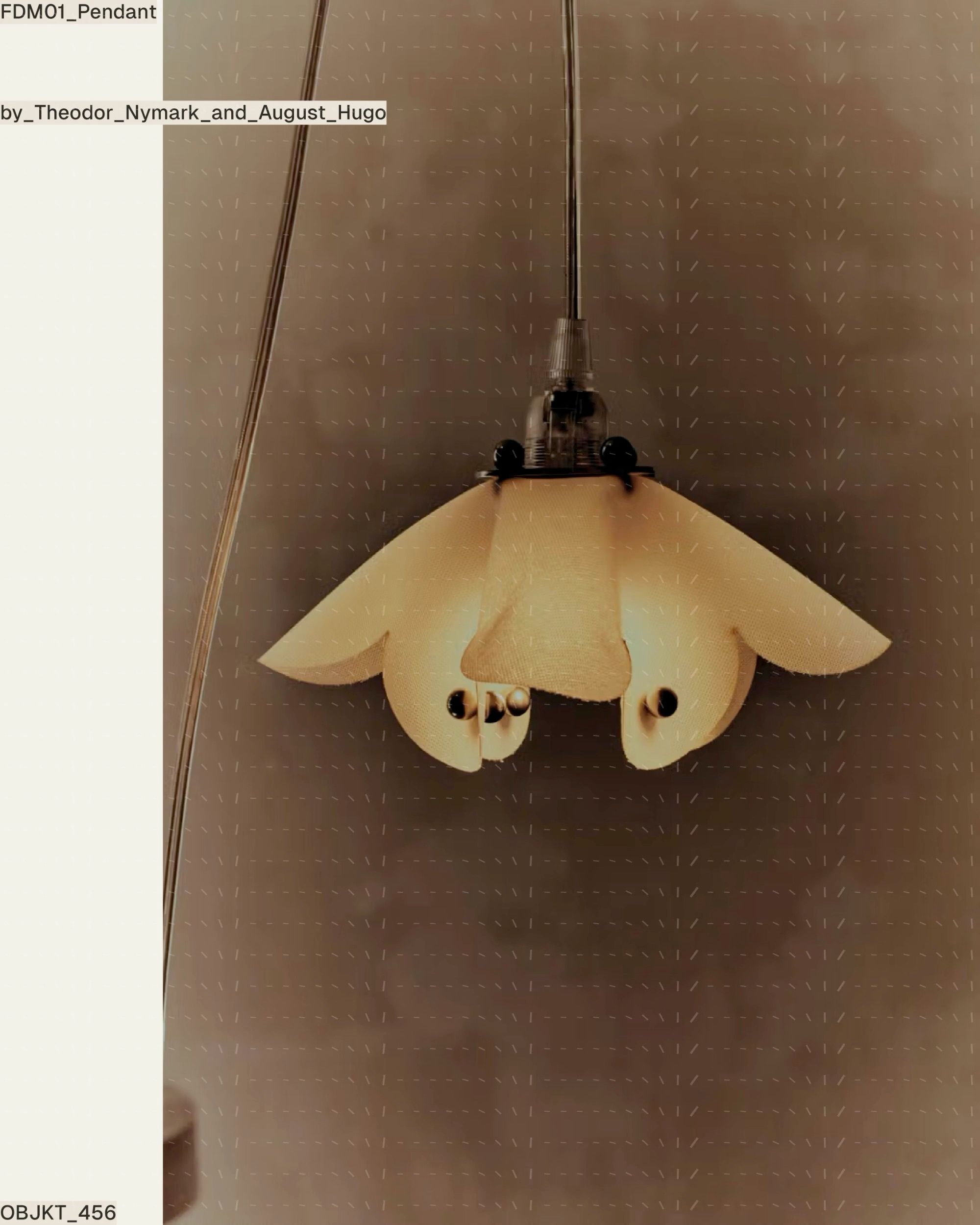 Lit petal-form pendant with dark bead fasteners against a dark wall.