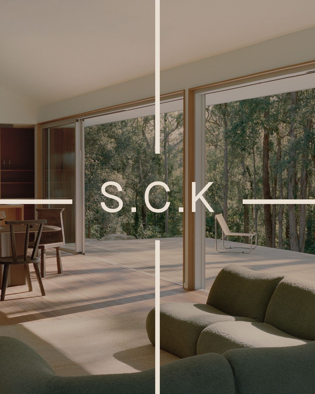 S.C.K and a crosshair over an interior looking out to a timber deck and forest.