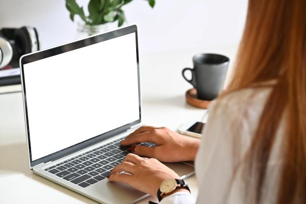 A woman typing on her laptop