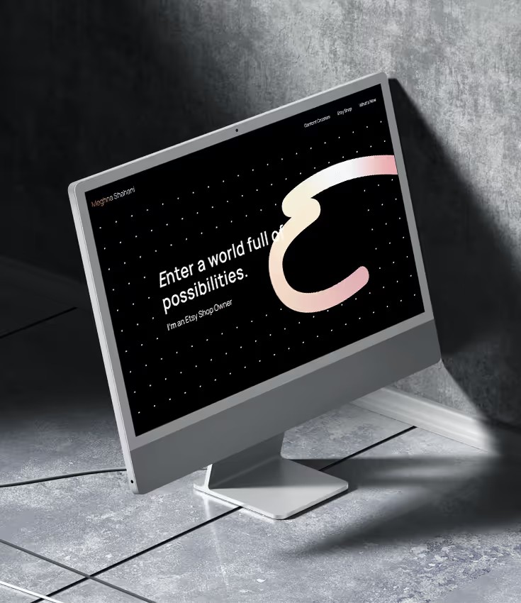 Meghna Shahani portfolio homepage, 'Enter a world full of possibilities', on a desktop monitor