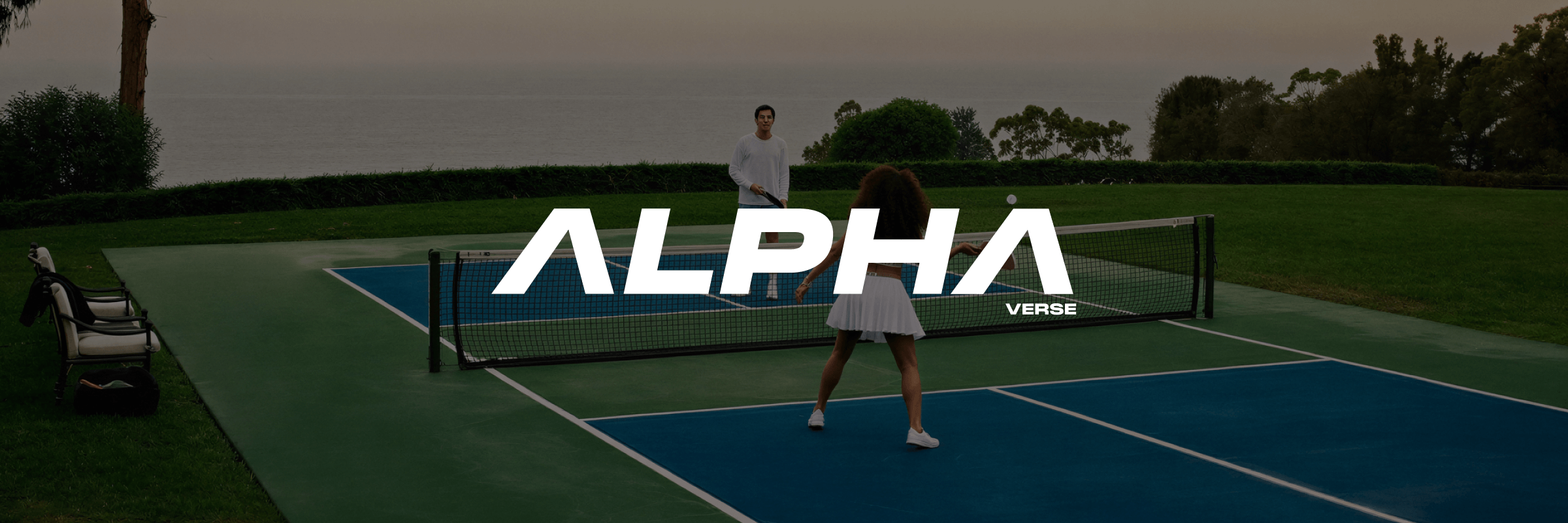 Alphaverse logo in white over a photo of two people playing pickleball on a blue and green court by the ocean
