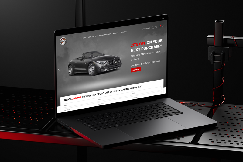 Softtops Online homepage on a laptop with a grey convertible and a 20% off relaunch offer