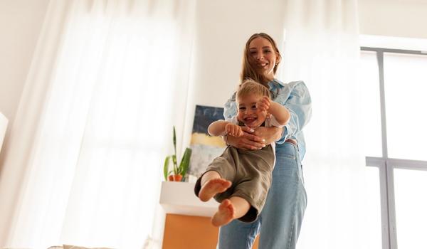 Bilde av en mor som leker med barnet sitt.