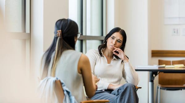 Bilde av to kollegaer som snakker sammen.