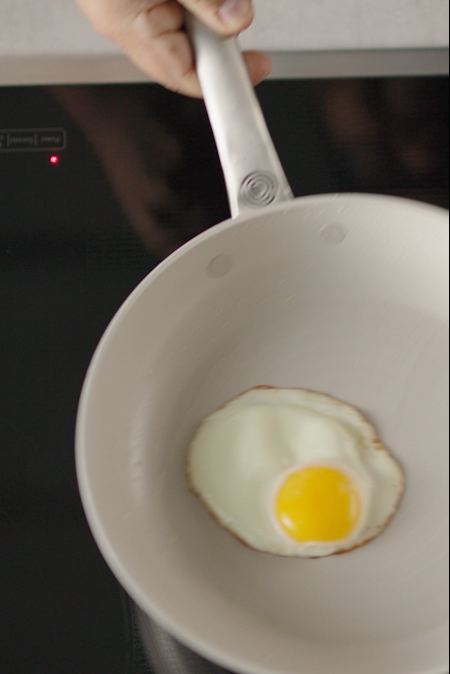 Egg cooking in a ceramic nonstick pan