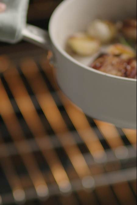 Ceramic saute pan being taken out of oven