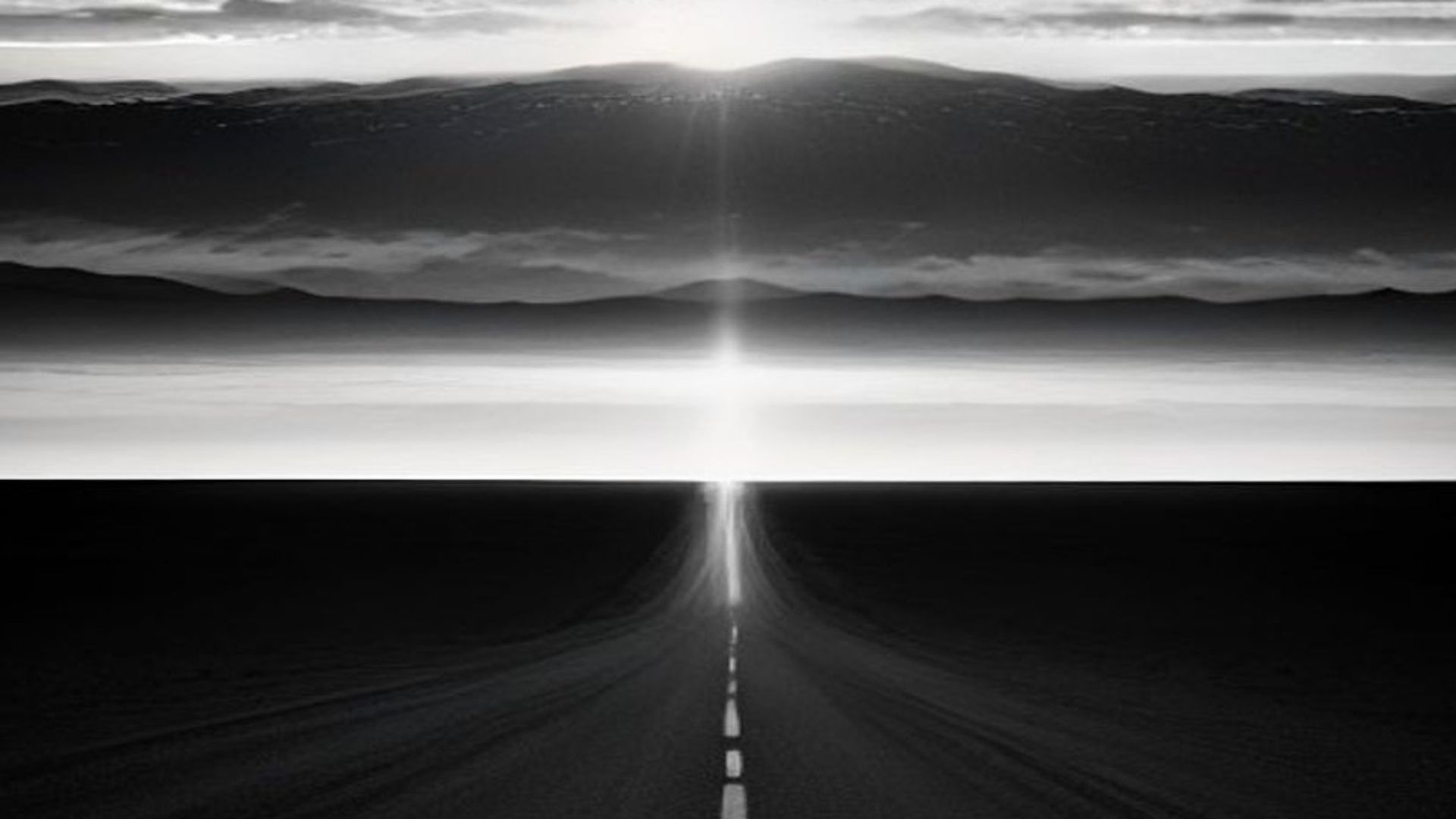 Ruta desierta al anochecer hacia el horizonte de Las Vegas, con una mano gigante de luz formándose entre las nubes