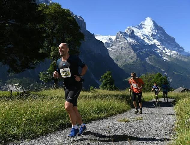 A Dragon running a mountain trail with the Eiger behind