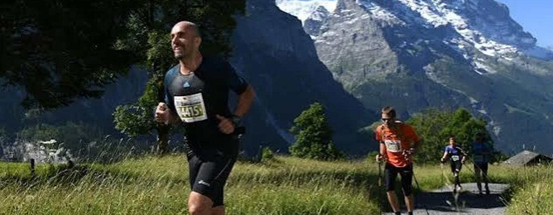 A Dragon running a mountain trail with the Eiger behind