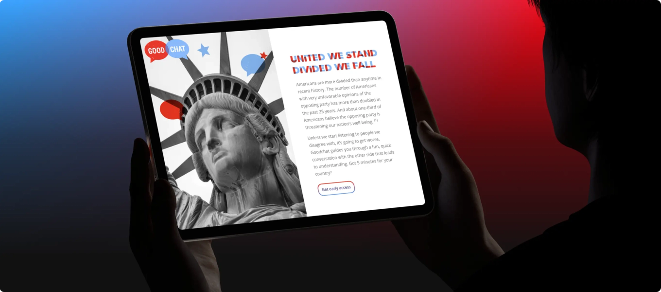 A person holding a tablet displaying the Good Chat landing page with text hat reads 'United We Stand, Divided We Fall'.