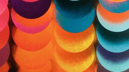 An abstract pattern of overlapping circles in a textured, grainy style, transitioning across warm oranges and reds on the left to cool blues and teals on the right.
