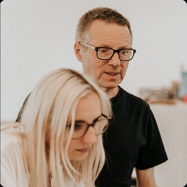 Gosia and Igor in an office, looking together at something off-camera