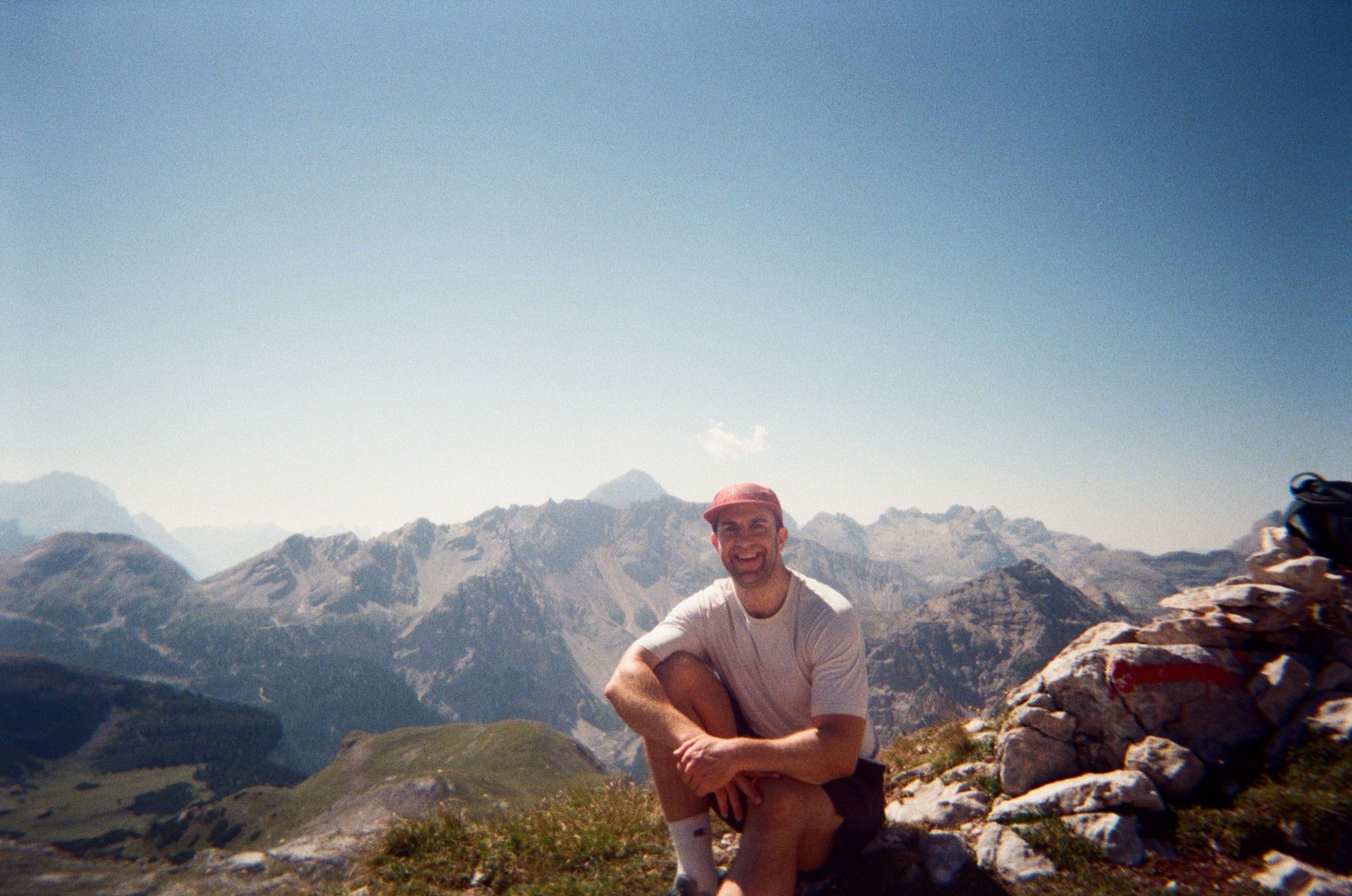Ryan sitting on a mountain ridge in the Dolomites