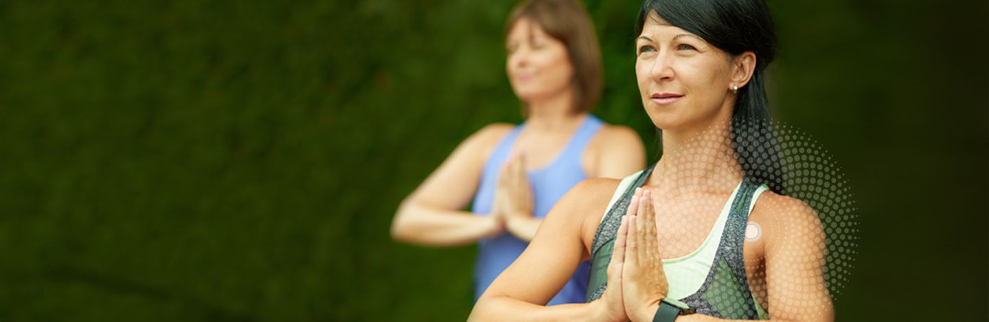 Two women doing yoga with a LifeWave patch on 